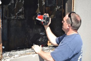 Lemoore Volunteer Firefighter John Gibson Jr. (shown here with a thermal imaging unit checking for hot spots) and Kings County Firefighter Roy Woodcock led an upstairs apartment dweller to safety as the fire burned below his apartment.